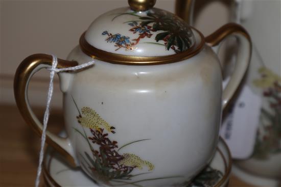 A Japanese Satsuma part coffee service, decorated with flowers and heightened in gilt, comprising coffee pot, cream jug,